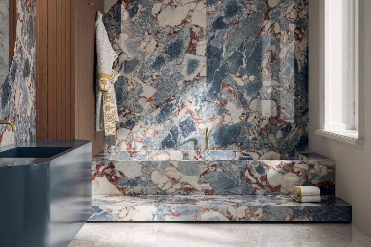 Versace Ceramics Harmony — Marble — Ocean Blue marble carved into a sculptural bathroom.